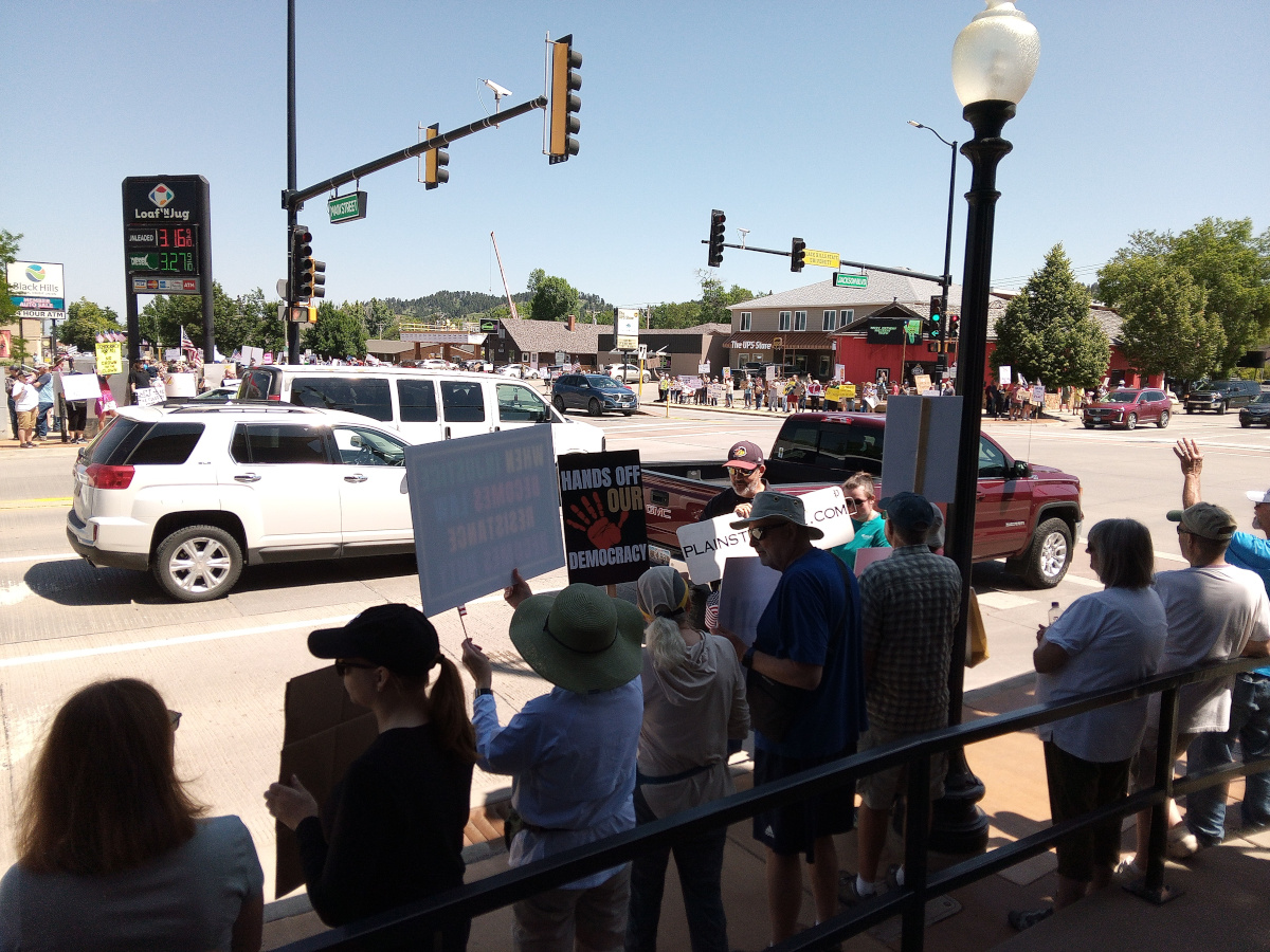 photo of people with signs at the Spearfish No Kings Event